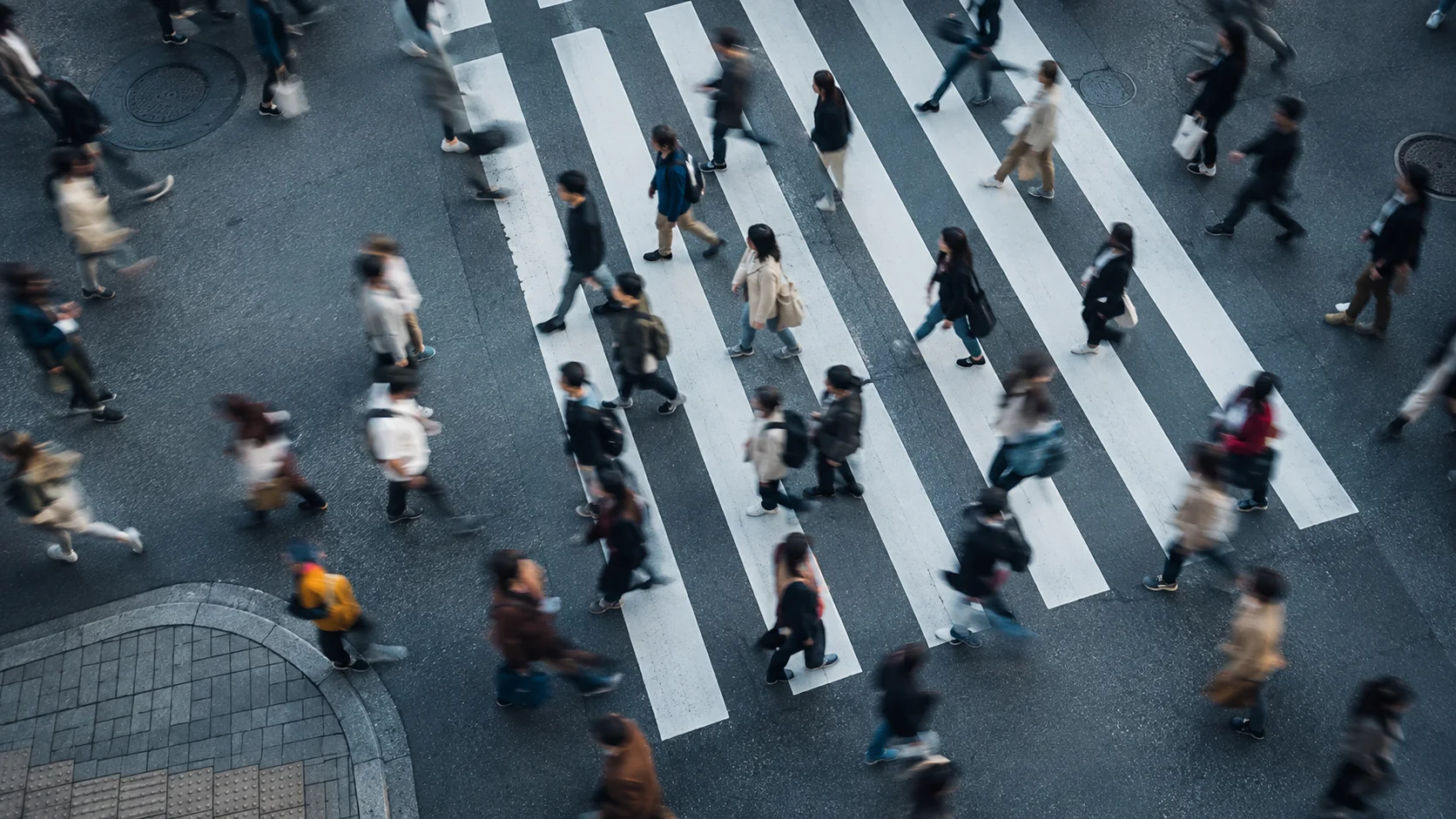 People crossing a city street from above